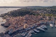 Aerial view of a mediteranean and hilly city with harbour