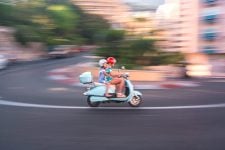 A woman and a child on a scooter on the monaco track