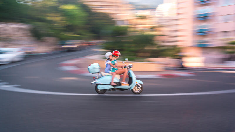 A woman and a child on a scooter on the monaco track