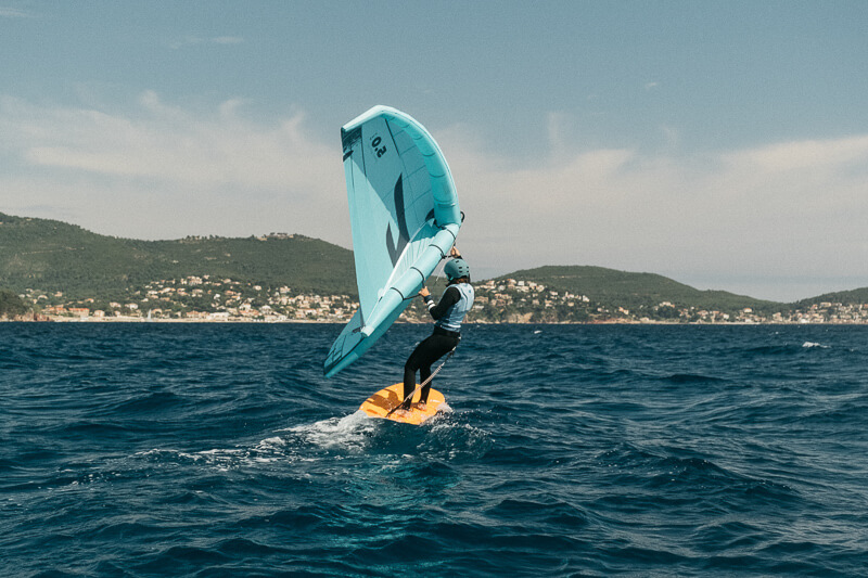 Someone who does windsurfing in Mediterranean sea next to Rocabella
